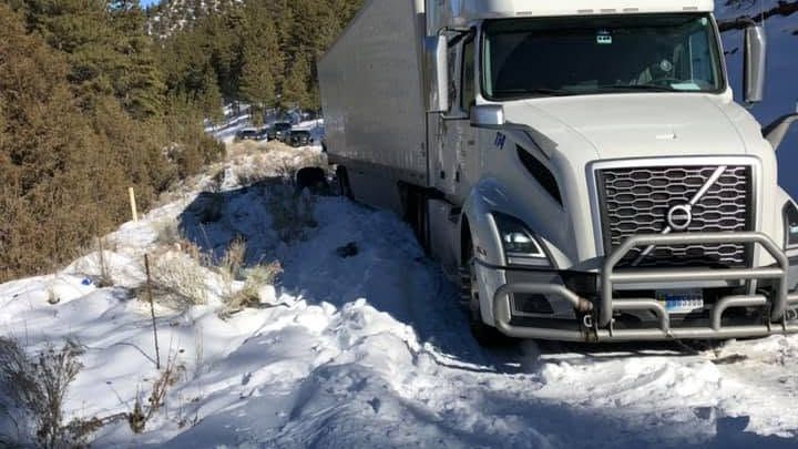 Semi truck in snow during a winter recovery by A&A Towing in western New Mexico