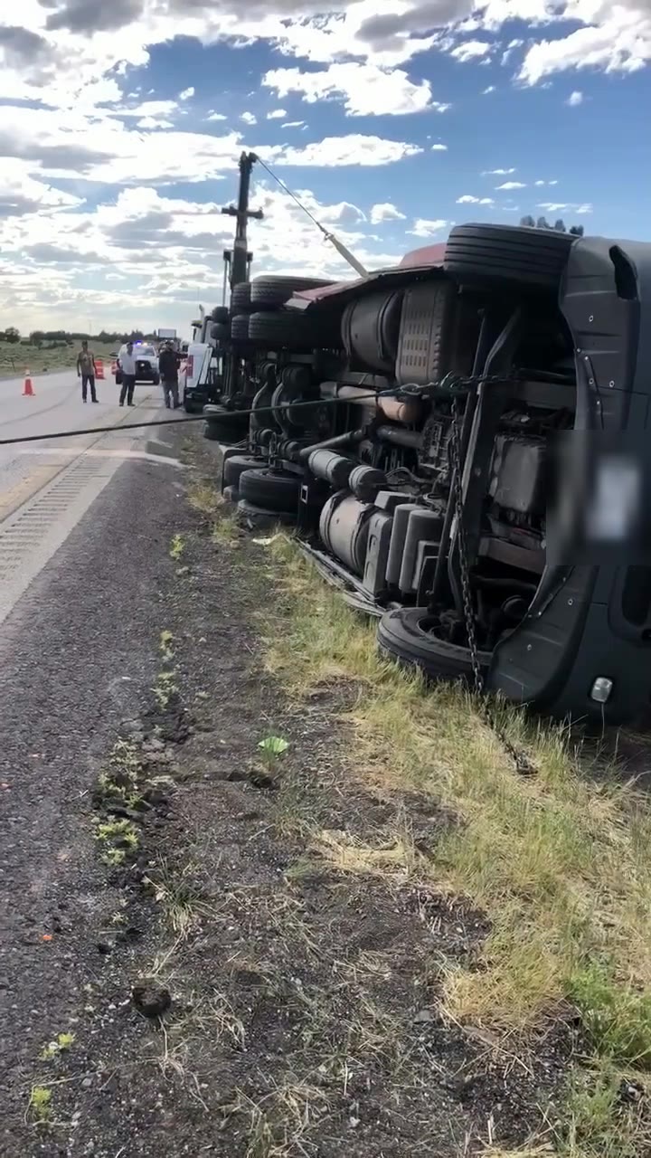 Overturned red semi on the I-40 shoulder before A&A uprighted it